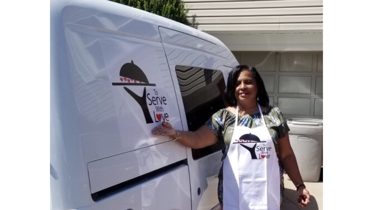 Diann Moore stands outside of her food delivery van