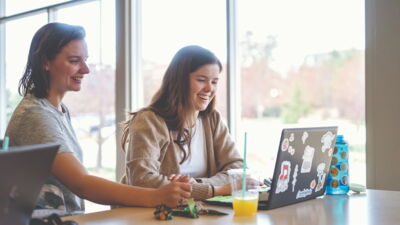 Two students smiling and studying in Janzow Top.