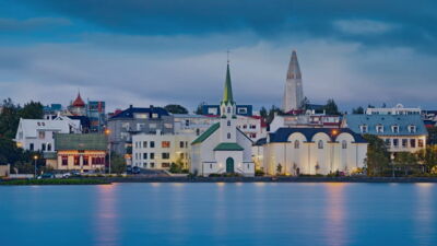 Overlooking the skyline of Reykjavik from the bay, with colorful buildings and church steeples 