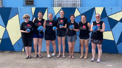 In front of painted wall at Fuente de Vida. Pictured from left to right: Julie Johnston Hermann, Macy Gebhardt, Rachel Johnson, Hayley Steinbauer, Chloe Dahn, Ashley Evans, and Erica Lamm