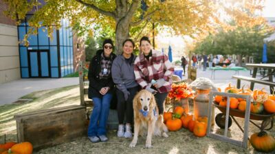 Three school nurses with an emotional support dog