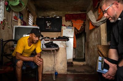 Photo courtesy of Johanna Heidorn, LAC missionary photographer. Rev. Joel Fritsche, right, prays with a parishioner in Pueblo Nuevo, Dominican Republic.