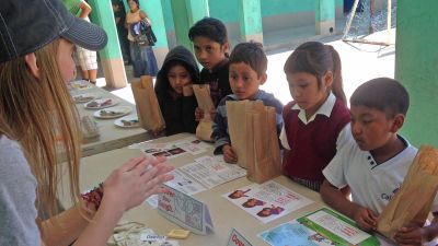 A student talking to children on a foreign mission trip