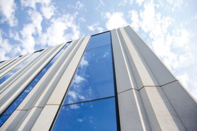 Outside view of the new Borland Center with stripes of windows reaching from the base to the roof. 