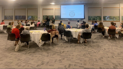 Grant Rohde and Grace Pennekamp present to students and faculty. 