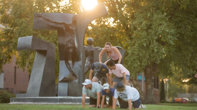 Students on quad making a human pyramid
