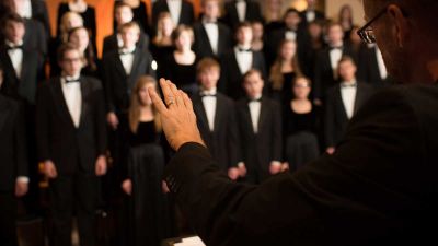 The Conductor of Concordia's A Cappella Choir leads during a Christmas at Concordia performance.