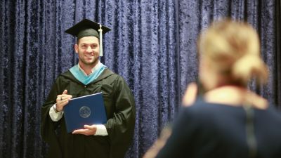 Student taking a graduation photo