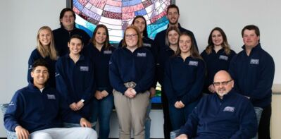 Members of the 2021 Collegiate Leadership Competition Team posed in front of the Borland Collaboration center stained glass window. 