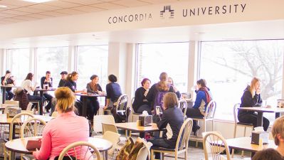 A picture of a full Janzow Cafeteria and students eating meals
