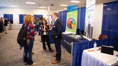 Students talking with a company representative at the career fair in Cattle Conference Room