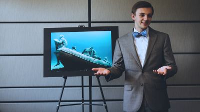 A male Concordia student presents a speech during a speech competition