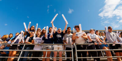 Concordia Nebraska students cheering in the stands at a football game