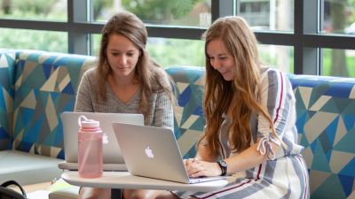 Two students reviewing academic policies at Concordia.