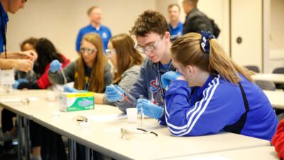 Ag summit attendees conducting a science experiment