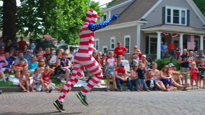 A man dressed as the American Flag in a 4th of July parade