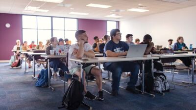 Concordia students in an education class have a small group discussion.