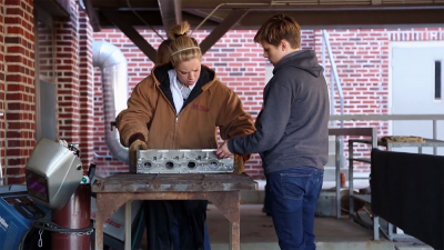 Two students taking a welding course