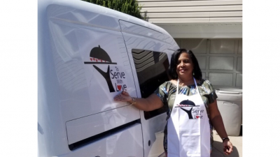 Diann Moore stands outside of her food delivery van 