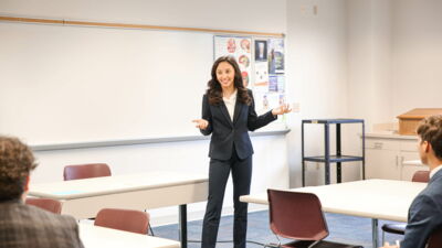 Speech Team member presenting while her other team members listen