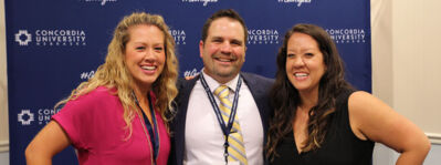 Three alumni posing for a photo