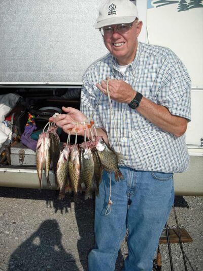 Don holding up fish he caught