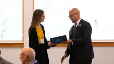Sarah Armbrust of St. Louis, Mo., one of Concordia's graduating seniors recognized for outstanding academic accomplishments, receives her honors from Dr. Tim Preuss, Concordia provost, during the University's Commencement Honors Dinner on May 6.
