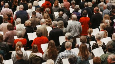 A congregation joined together in singing