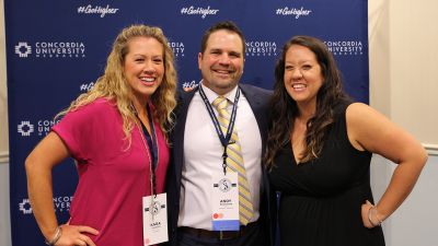 Three alumni posing for a photo