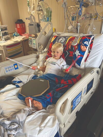 Paxton smiling in his hospital bed