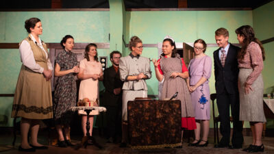 A group of students giving a performance of a murder mystery in victorian clothing