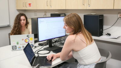 A student with a text editor open, working on a software project.