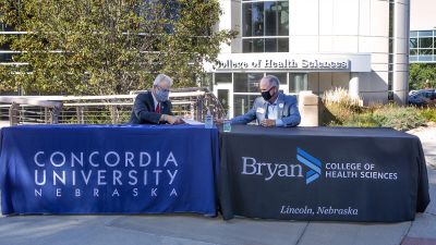 Rev. Russ Sommerfeld, Concordia interim president and Dr. Richard Lloyd, Bryan College of Health Sciences president, sign a dual degree partnership agreement Sept. 2.