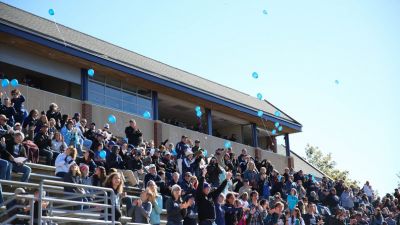 Students cheering in football bleachers