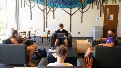 Students sit in Janzow Campus Center spaced 6-feet apart and wearing their face coverings.