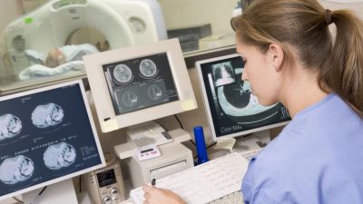 A student looking at MRI brain scan images