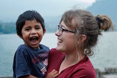 Student laughing with a local boy on a mission trip