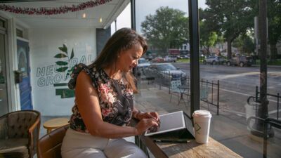 Graduate student working on her iPad in a coffee shop