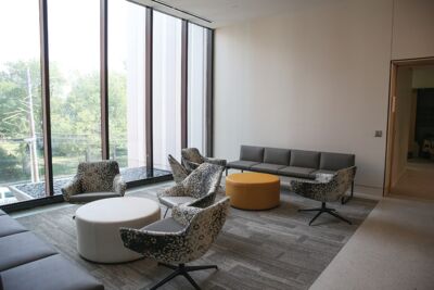 Interior lounge area of the Borland Center with a picture window overlooking the street. 