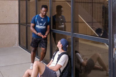Two student chatting outside a building on campus