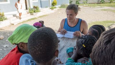 A Concordia student works with students in Haiti