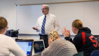 Professor lecturing to students during a class