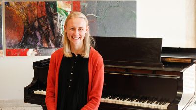 Concordia student Charlotte Lines sitting at a piano