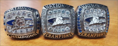 Three national championship rings resting on a table